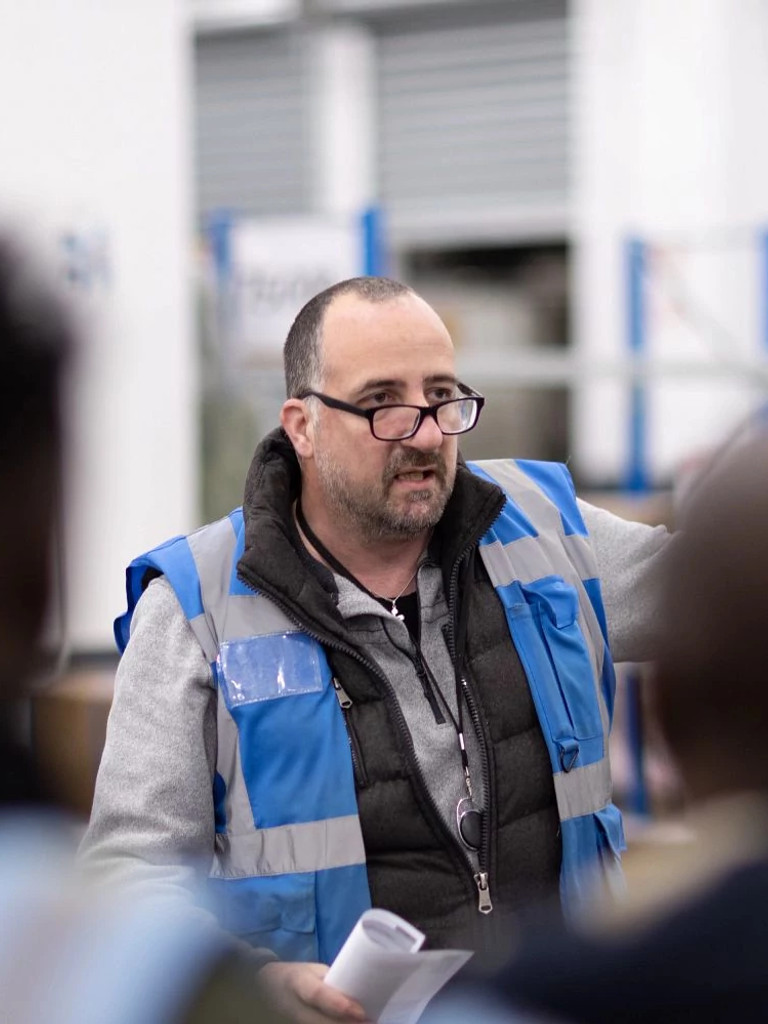 Premiere Couriers supervisor briefing a team of drivers